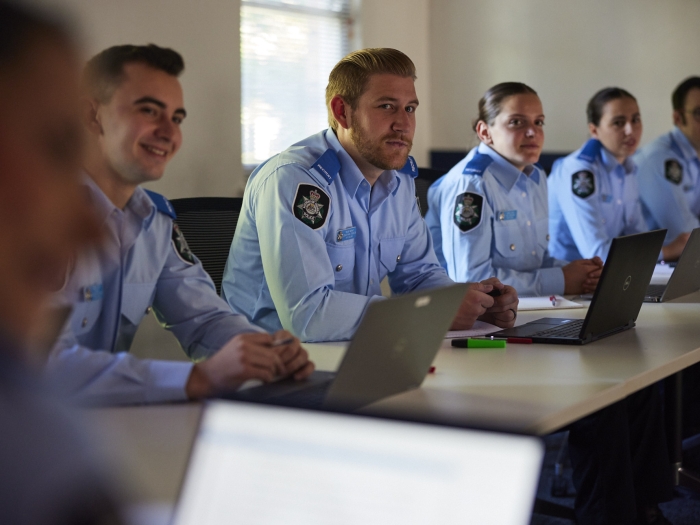 Five AFP recruits sitting at a desk