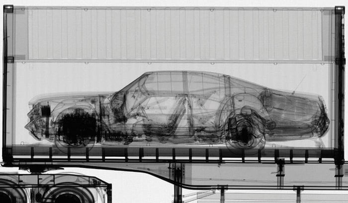 An xray showing a vehicle inside a shipping container