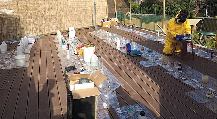 Items used for producing drugs spread out on a deck, being inspected
