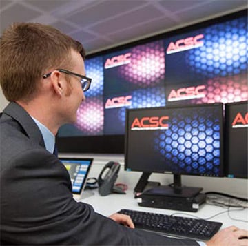 A man using a computer at the Australian Cyber Security Centre.