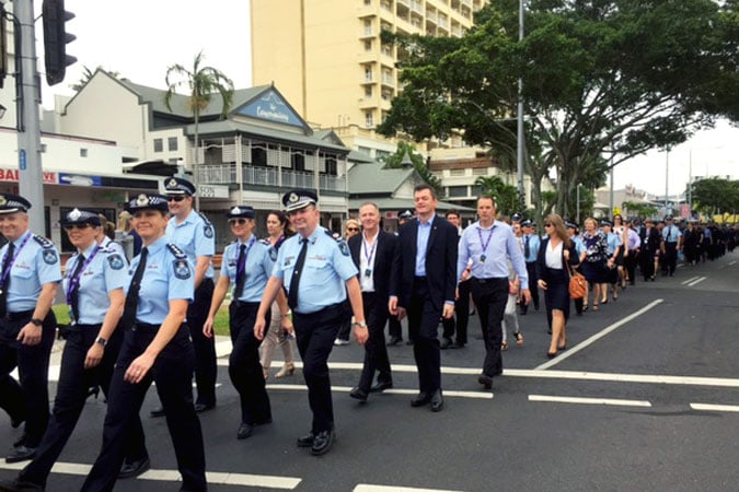 AFP Commissioner Andrew Colvin (middle ground) takes his place in the parade of nations through Cairns to begin the 2017 International Women & Law Enforcement conference.