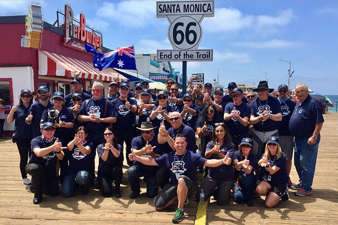 Job done! The inaugural Route 66 group celebrate the ‘end of trail’ on the iconic timbers of Santa Monica Pier