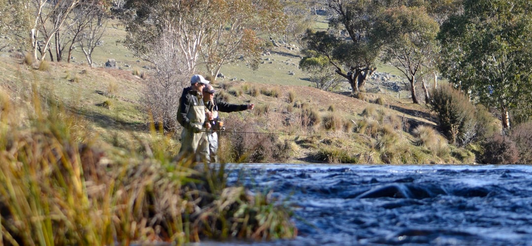Two men fly fishing in a river