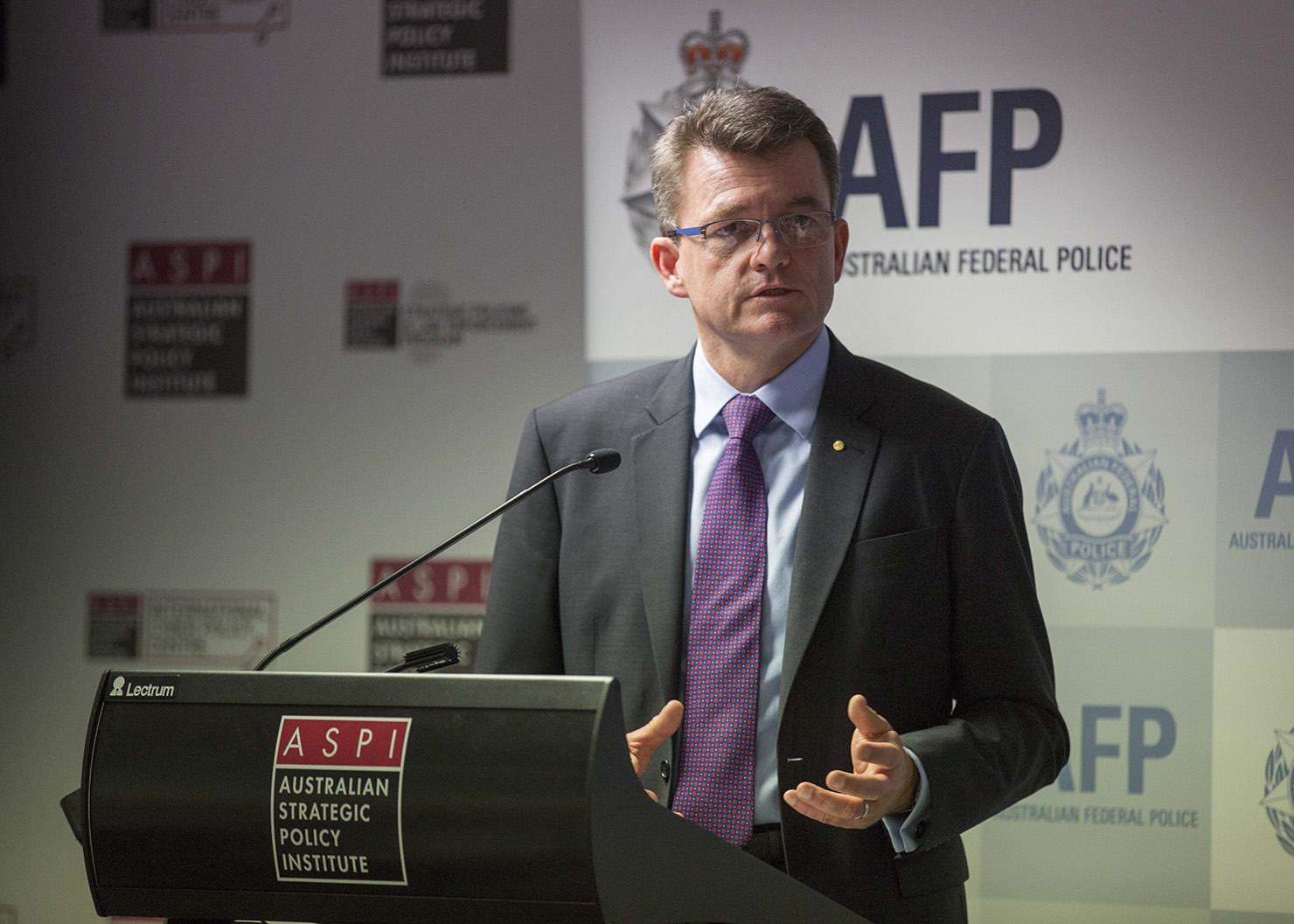 The AFP Commissioner speaking at a lecturn