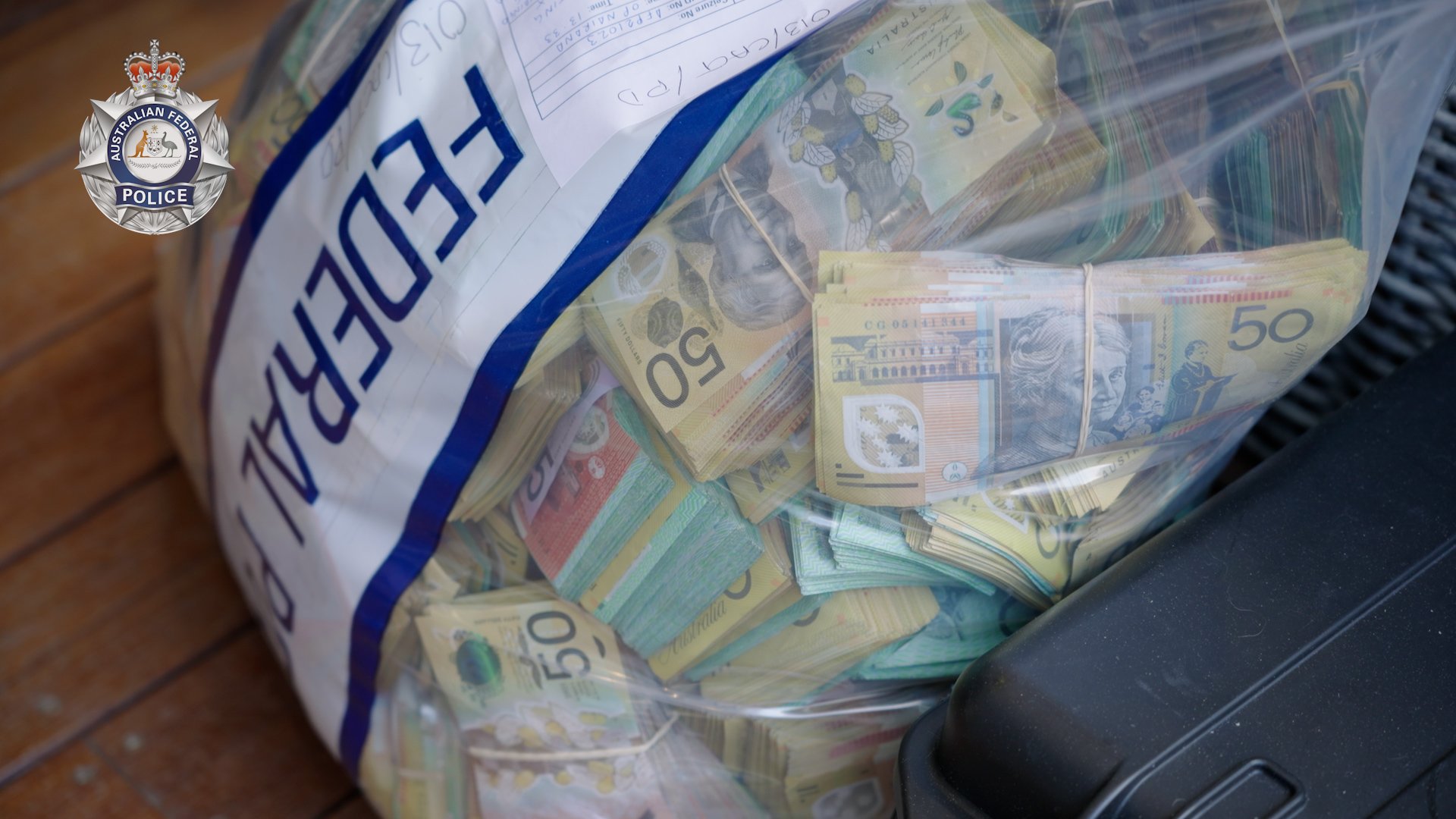 Bundled Australian bank notes in an AFP evidence bag