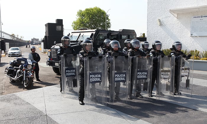 A squad of multiple riot police with shields