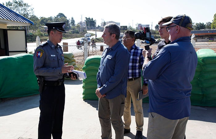 A uniformed officer being interviewed by a man