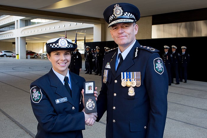 Female police officer shaking hands with the AFP Commissioner