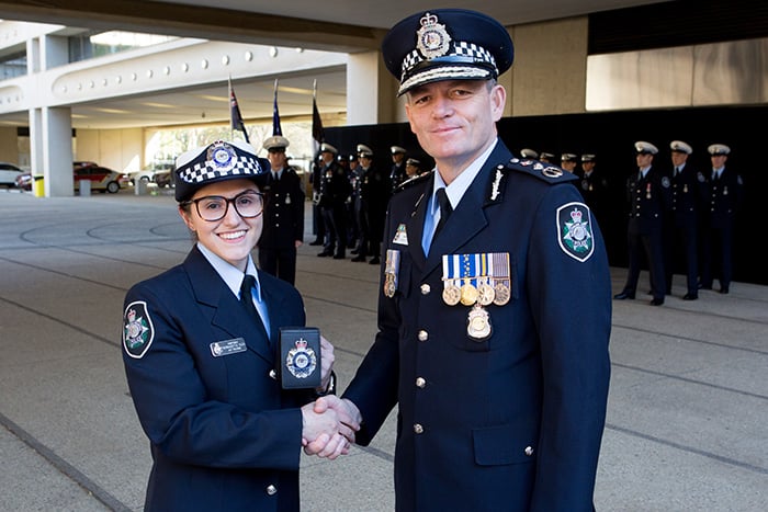 Female police officer shaking hands with the AFP Commissioner