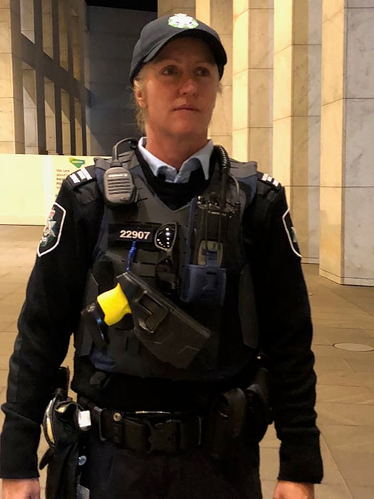 A female Protective Service Officer in uniform on duty