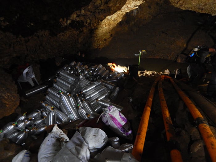 A large stack of silver air tanks inside the cave