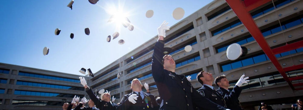 AFP graduate throwing their caps in the air