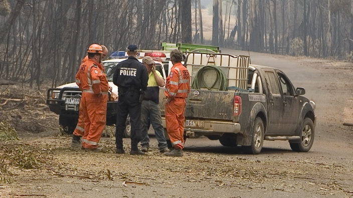 AFP Officer meets with SES personnel and Victorian resident as part of their deployment following the ‘Black Saturday’ Bushfires of 7 February 2009 (AFPM12890)