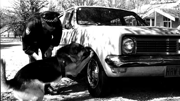 1983: Senior Constable Garry Baker with the AFP’s first canine, Kaiser (AFPM9287)