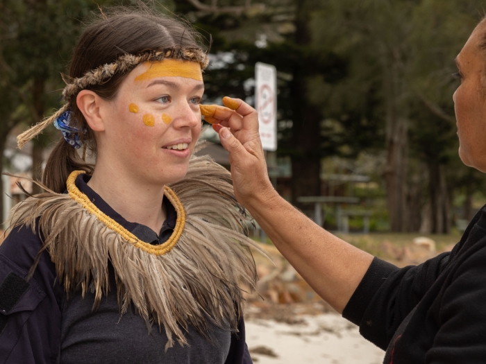 Two first nations women preparing cultural face paint