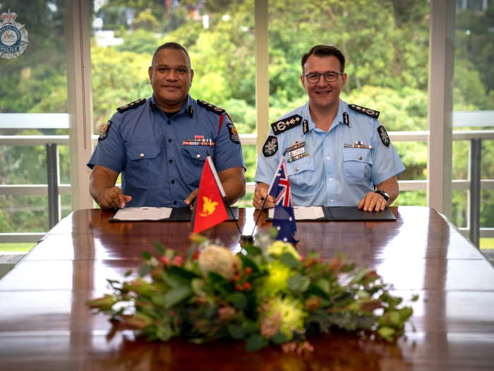 AFP Commissioner and Papua New Guinea Police Constabulary Commissioner signing new partnership agreement 2022