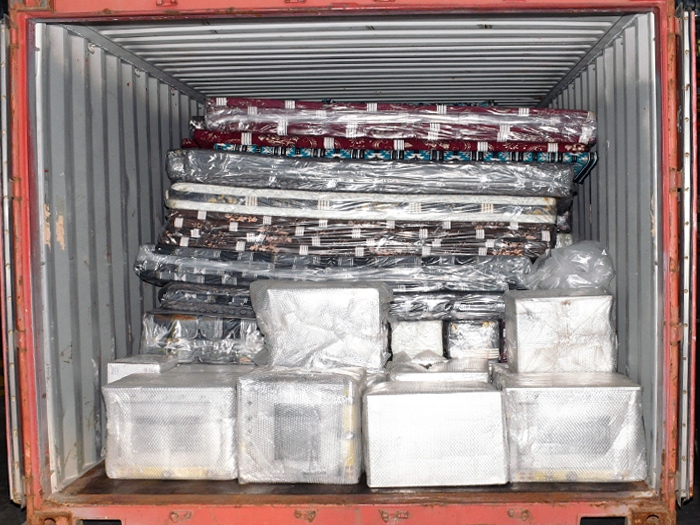 A shipping container filled with wrapped packages