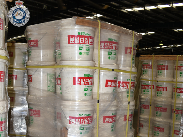 White tubs containing MDMA stacked on pallets
