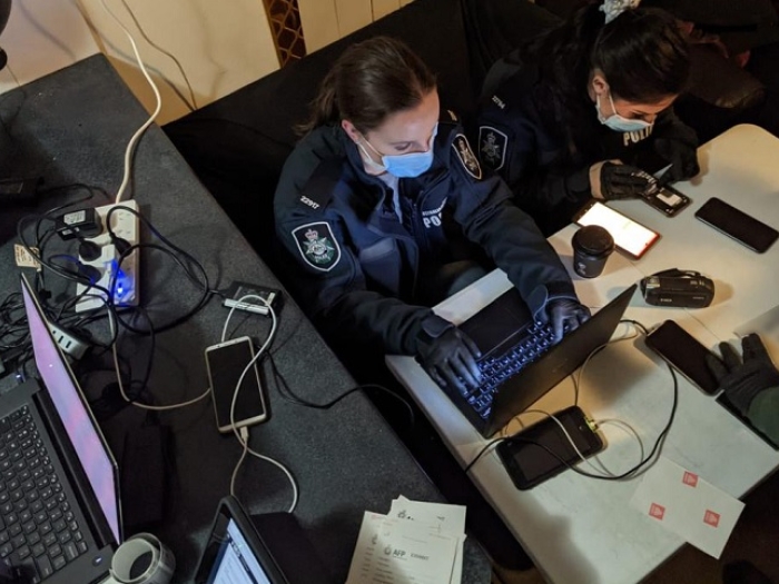 AFP investigators examined electronic devices during a search warrant in Chippendale