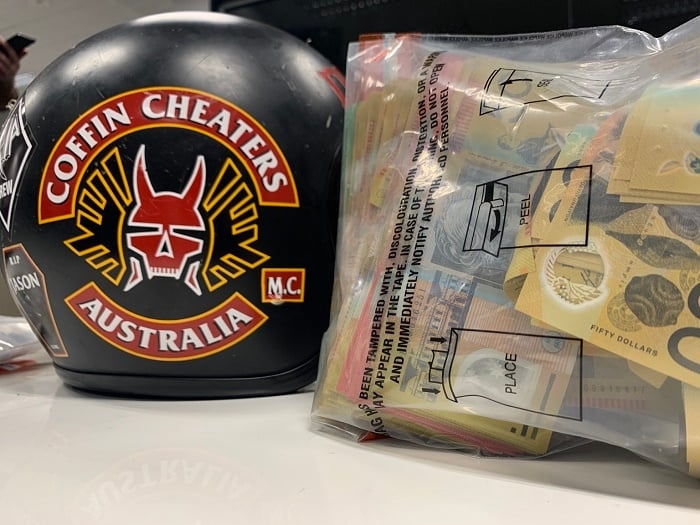 Coffin Cheaters OMCG helmet and seized cash