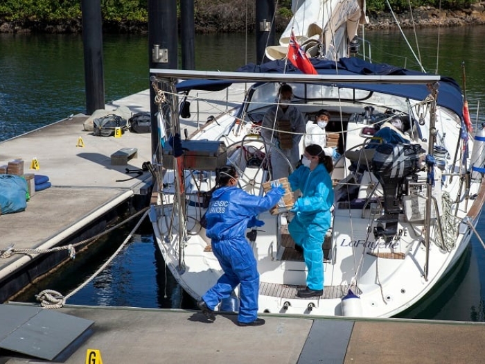 Boxes of drugs being removed from yatch by forensics
