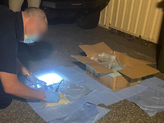 Investigators searched a bin and allegedly found five kilograms of methamphetamine in a cardboard box.
