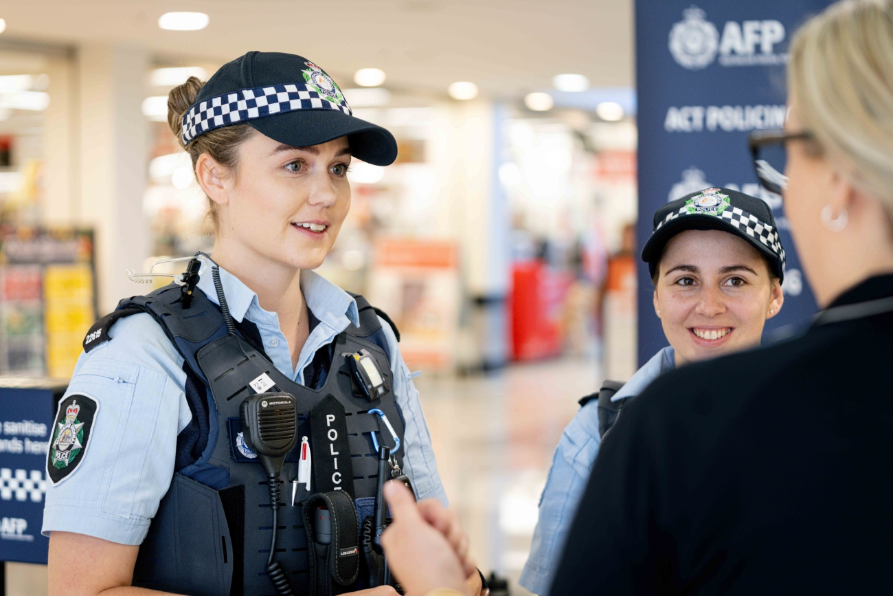 Two ACT Policing officers talking to a member of the public