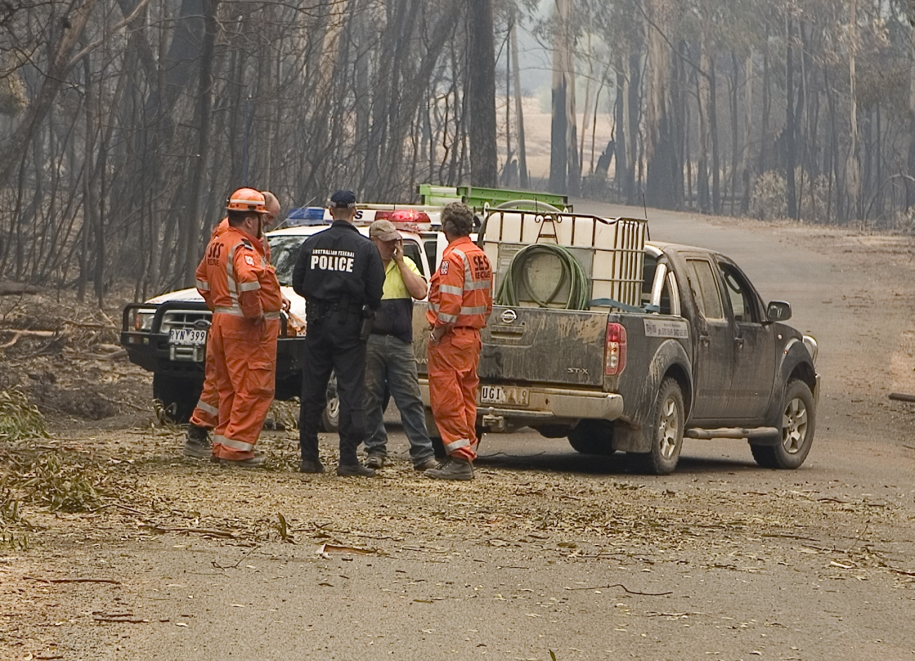 AFP Officer meets with SES personnel and Victorian resident as part of their deployment following the ‘Black Saturday’ Bushfires of 7 February 2009 (AFPM12890)