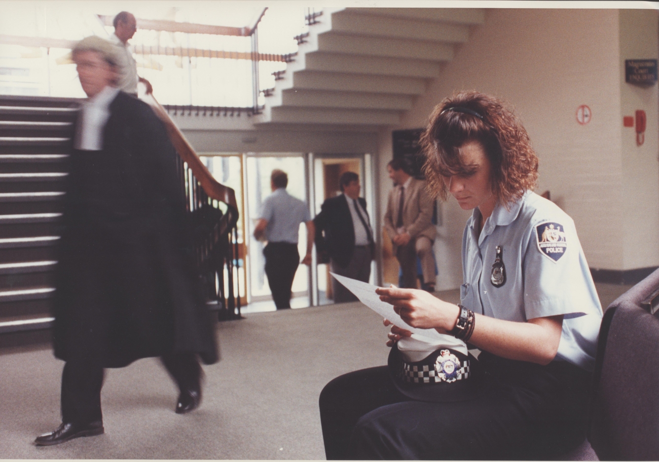 An AFP officer (in slacks) preparing to give evidence in the ACT Magistrates Court in 2001 (AFPMRN445)