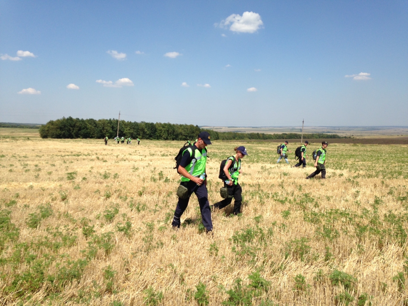 Sworn members of the ACT Policing Disaster Victim Identification (DVI) team, Specialist Response Group and Protective Service Officers searching the flight MH17 crash zone for evidence AFPM10558