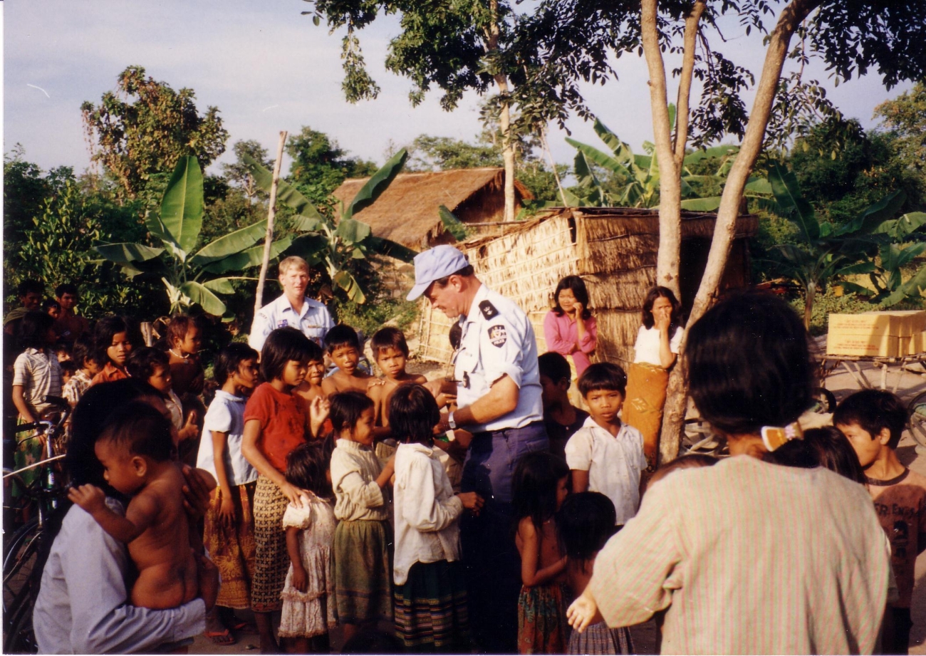 AFP peacekeepers handing out sweets to a group of children in Cambodia, 1993 AFPM4727