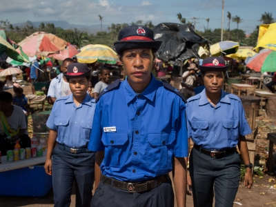 Female police officers walking through a market