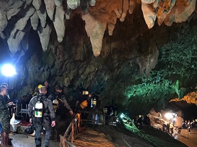 Divers at the entrance of the Tham Luang Nang Non cave, Thailand.